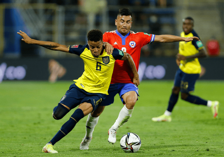 SANTIAGO, CHILE - NOVEMBER 16: Byron Castillo of Ecuador and Jean Meneses of Chile fight for the ball during a match between Chile and Ecuador as part of FIFA World Cup Qatar 2022 Qualifiers at San Carlos de Apoquindo Stadium on November 16, 2021 in Santiago, Chile. (Photo by Marcelo Hernandez/Getty Images)